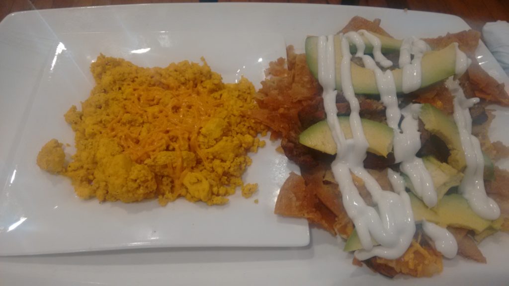 Chilaquiles & tofu scramble topped with vegan cheese